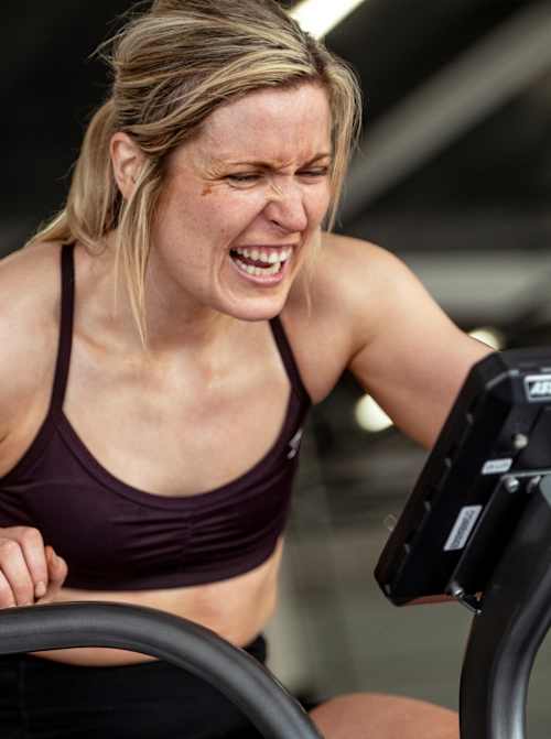 On 6th August 2025, a determined participant trains on a fitness bike at the Red Bull Pit Race during the Red Bull Hyrox coaches camp, Silverstone Circuit, UK, epitomising Red Bull energy