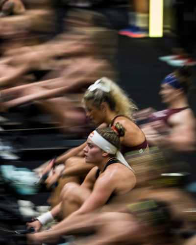 HYROX Elite 15 athlete Lucy Procter rowing at a HYROX competition