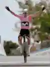 Annemiek van Vleuten crosses the finish line with her hands in the air