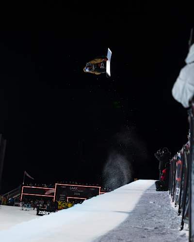 On January 17, 2026, Scotty James catches air in the halfpipe at the Laax Open in Laax, Switzerland, with crowds and cameras capturing the dynamic moment.