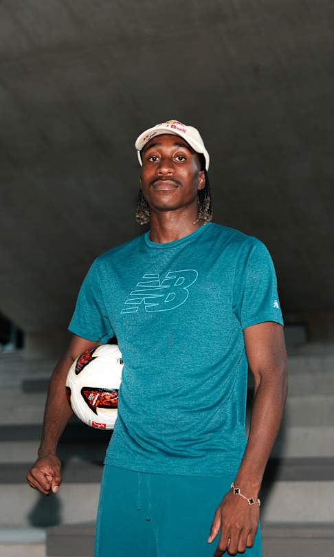 Yan Diomandé poses with a football during a portrait photoshoot in Saalfelden, Austria, in 2026, wearing New Balance apparel.