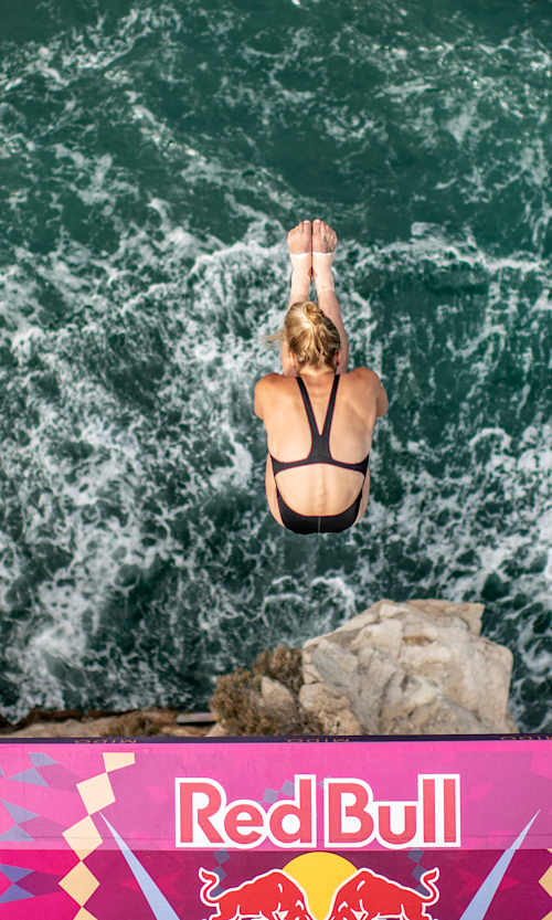 Aimee Harrison of Canada dives during the final competition day of the fifth stop of the Red Bull Cliff Diving World Series at Polignano a Mare, Puglia, Italy on September 22, 2021.