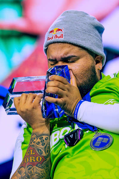 MenaRD kisses his championship trophy after his Street Fighter 6 Grand Final win at EVO Championship Series in Las Vegas, Nevada, USA on August 3, 2025