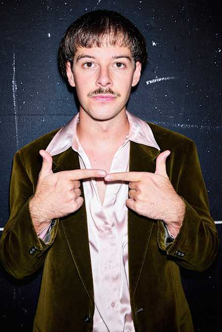 Topffrisur, Schnauz und ernstes Gesicht: So kennt man Creator Aditotoro.