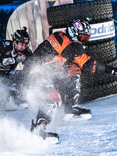 Red Bull Crashed Ice competitors fight for position through a corner in Saint Paul, USA.
