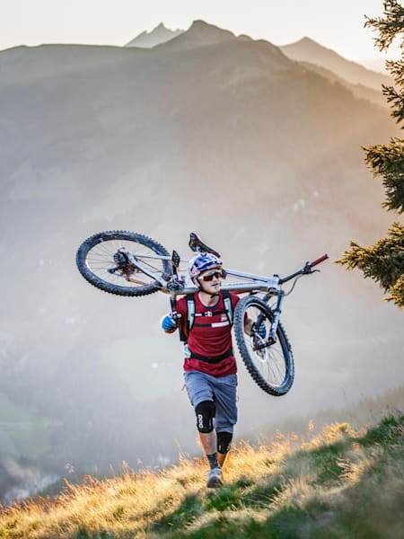 Top 9 des raids VTT en 2020 : Tom Oehler porte son VTT lors d'un raid à Weissenhofalm en Autriche.