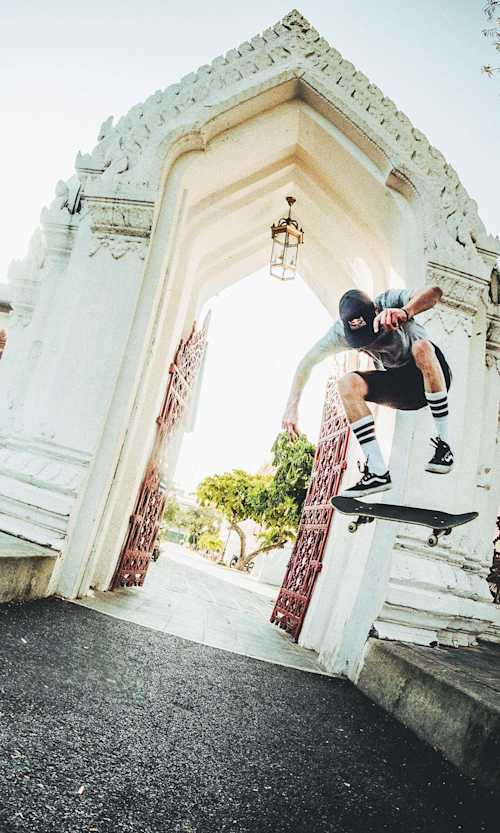 Skater Maxim Habanec Backside Heelflips over a road gap in Bangkok, Thailand during filming for his Skate of Mind video series