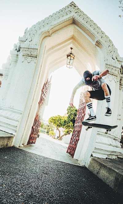 Skater Maxim Habanec Backside Heelflips over a road gap in Bangkok, Thailand during filming for his Skate of Mind video series