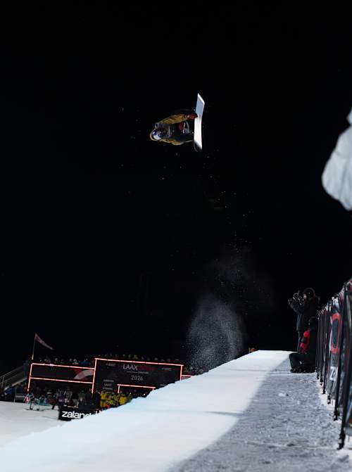 On January 17, 2026, Scotty James catches air in the halfpipe at the Laax Open in Laax, Switzerland, with crowds and cameras capturing the dynamic moment.
