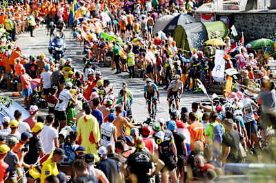 Thousands of fans line the route as riders make their way to Alpe d'Huez