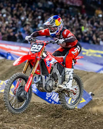 Riders tackle technical obstacles during a Supercross main