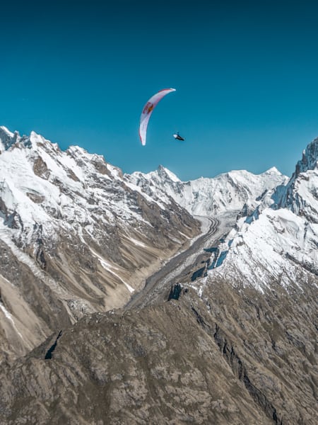 Paragliding pilot Tom de Dorlodot soars above the Baltoro Glacier in Pakistan on June 28, 2022.