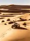 A car races across the sand dunes for the Dakar Rally.