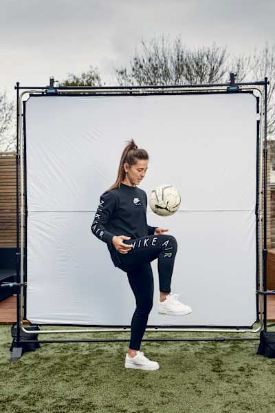 Fara Williams performs keepy-uppies with a football.