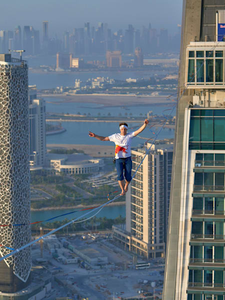 Jaan Roose slacklining between the Crescent Towers in Doha, Qatar on 19 June, 2023.
