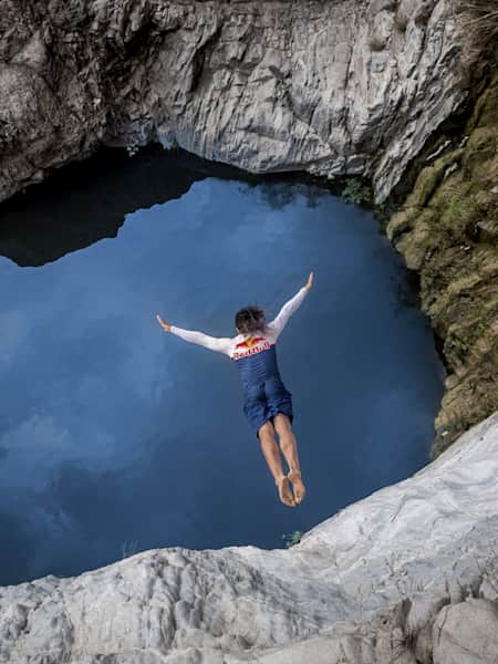 Catalin Preda of Romania dives from a cliff at Wadi Al Rogh during a Red Bull Cliff Diving adventure in Saudi Arabia on February 27, 2024.