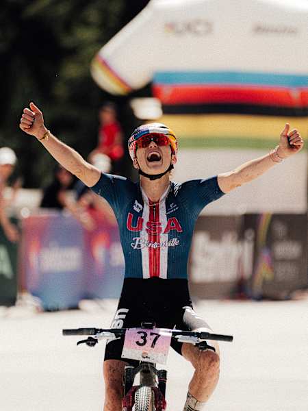 Kate Courtney celebrates winning the Cross-Country Marathon event at the UCI MTB World Championships in Valais, Switzerland on September 6, 2025. 