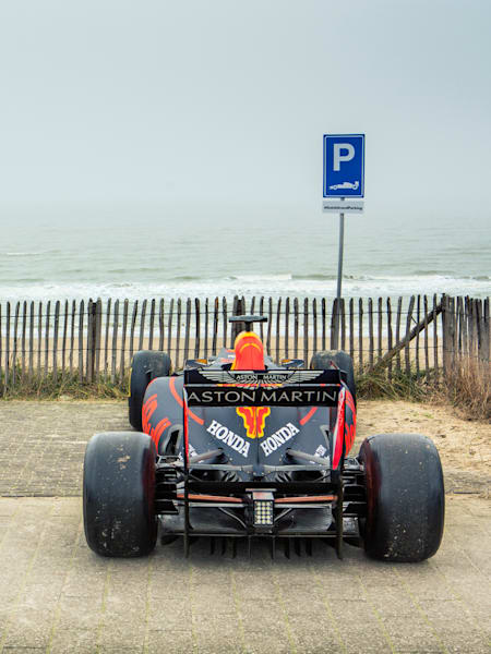 A photo of the Aston Martin Red Bull Racing F1 car on Zandvoort beach.