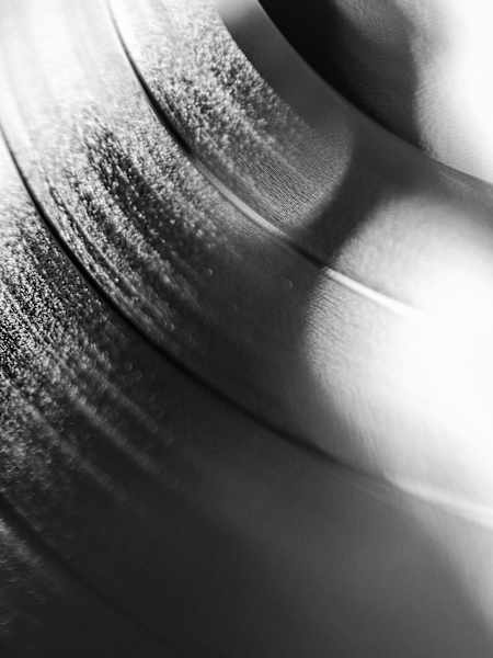 A black and white photo of a vinyl record.