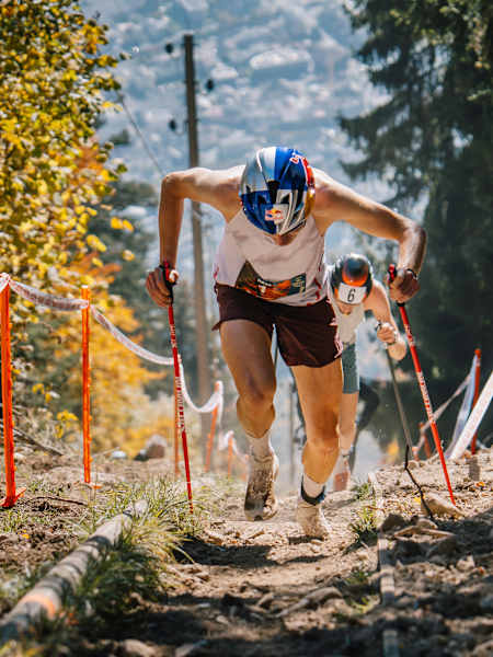 Rémi Bonnet running uphill with poles at the Fully Vertical Kilometre in Fully, Switzerland