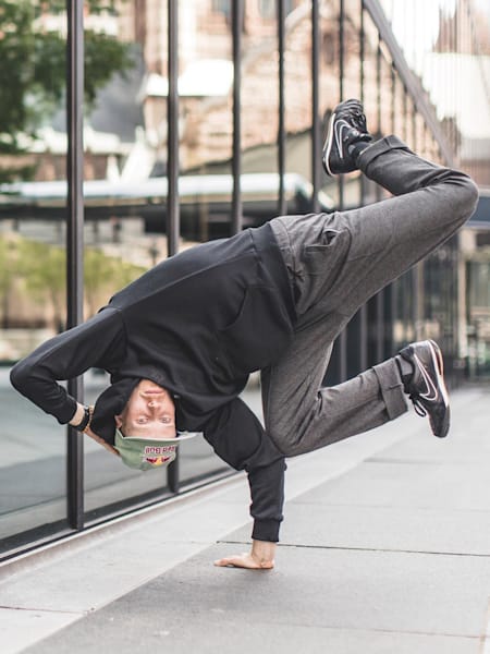 Benno balances on his right hand in an airbaby pose