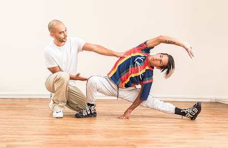Jenso from HE4DS helps a dancer with his stretching.
