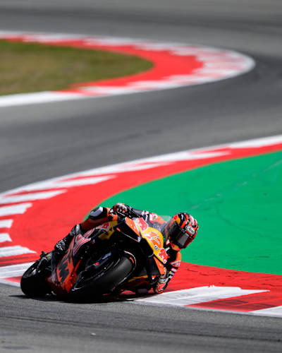 Maverick Viñales carves through the Catalunya MotoGP circuit for Red Bull KTM in Barcelona during the 2025 season, showcasing high-speed racing on the challenging curves