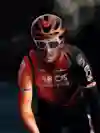 Welsh cyclist Geraint Thomas seen riding in the black and orange uniform of the Ineos Grenadiers team.