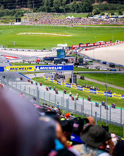 High-energy moments from the 2025 MotoGP World Championship as competitors race at the Red Bull Ring in Spielberg, Austria, with fans watching the packed circuit