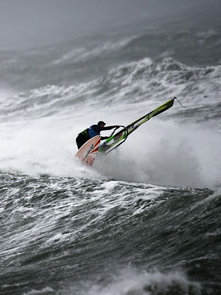 A windsurfer hits a wave backside at Red Bull Storm Chase in Ireland