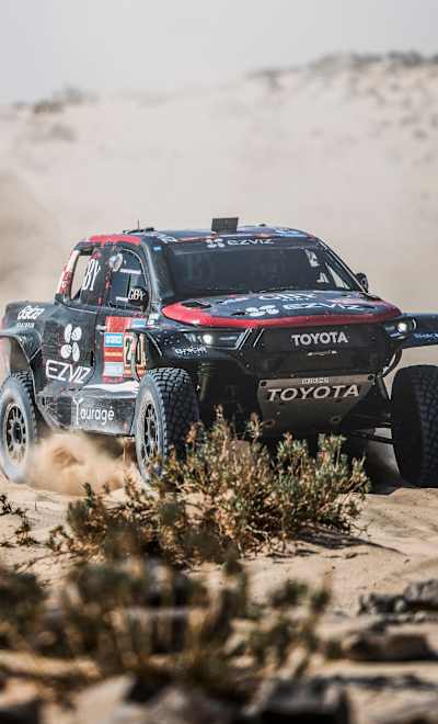 On January 14, 2025, Rokas Baciuška races his Overdrive Racing Toyota at full speed during stage 9 of Rally Dakar, carving through the Arabian desert from Riyadh to Haradh in Saudi Arabia.