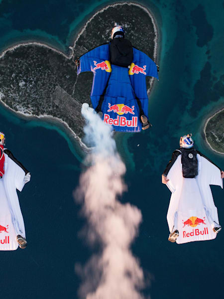 Marco Waltenspiel, Amy Chmelecki and Marco Fuerst fly with their wingsuits over the heart island near Zadar, Croatia, November 30, 2016
