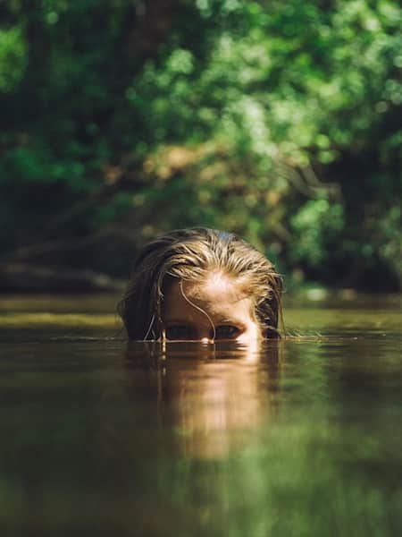 woman swimming in the water, but you can see only half of the face