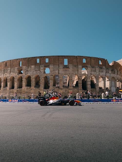 A F1 car in front of the Colosseum in Rome, Italy.