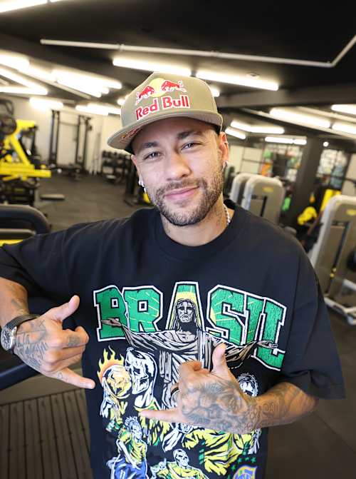 Brazilian footballer Neymar Jr salutes the camera in a gym