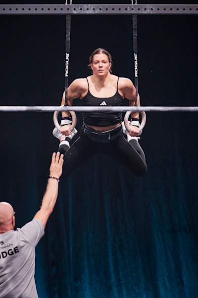 Laura Horváth performs muscle-ups on the rings at the World Fitness Project Final in Copenhagen, Denmark on December 21, 2025.