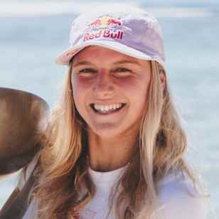 Molly Picklum proudly displays the WSL Women’s World Title trophy at Cloudbreak, Fiji after her 2025 championship win.
