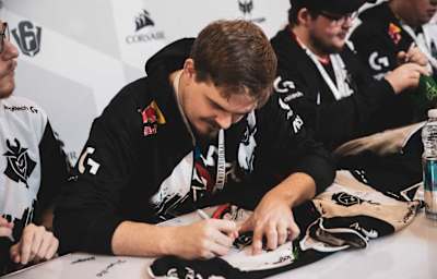 Fabian of pro Esports team G2 signs some fan jerseys.