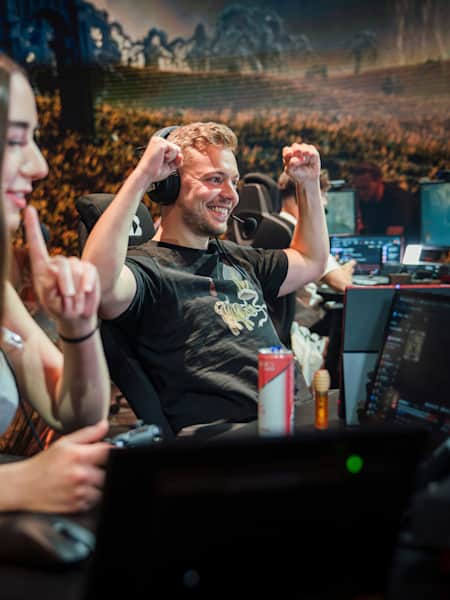 Elajjaz and Miss Mikaa celebrating beating a Shadow of the Erdtree boss at Red Bull Levels Elden Ring event in Berlin