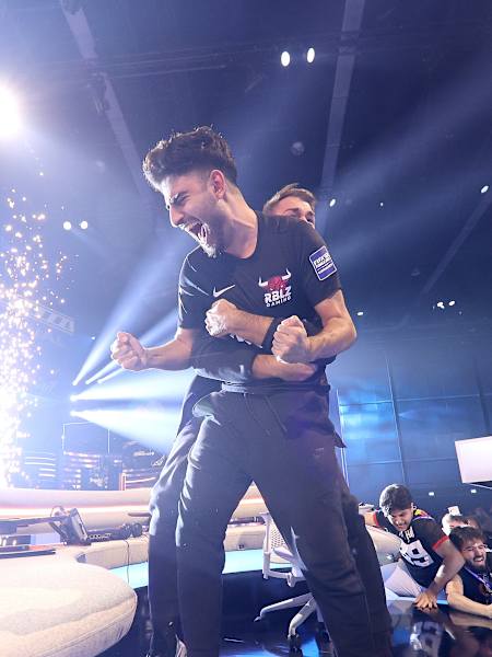 Esports athlete Umut Gültekin and coach Daniel Fehr celebrate victory in the final of the FIFAe World Cup.