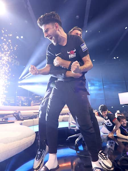 Esports athlete Umut Gültekin and coach Daniel Fehr celebrate victory in the final of the FIFAe World Cup.