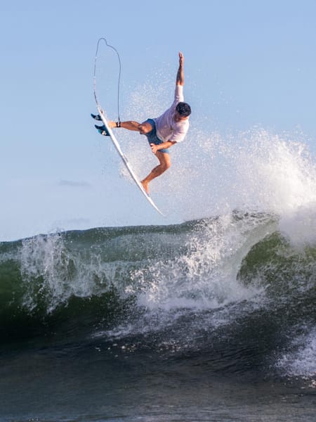 Lee Wilson launches an aerial while surfing in Bali, Indonesia