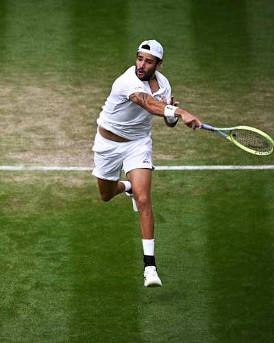 Italy's Matteo Berrettini returns the ball to Germany's Alexander Zverev during their men's singles tennis match at the 2023 Wimbledon Championships.