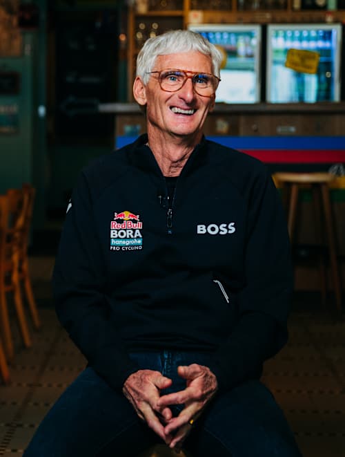 Allan Peiper represents Red Bull - BORA - hansgrohe during a Eurosport 2026 interview in Geraardsbergen, Belgium, emphasising the team's presence in professional cycling