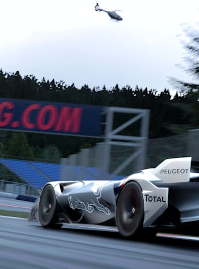 A Peugeot L750R Hybrid Vision Gran Turismo takes a long corner on the Red Bull Ring in the game Gran Turismo 7.