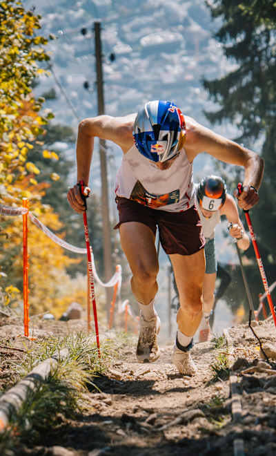 Rémi Bonnet running uphill with poles at the Fully Vertical Kilometre in Fully, Switzerland