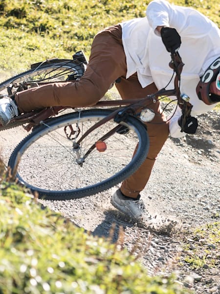 Fabio Wibmer rides down a trail on the Saalbach downhill course on a city bike