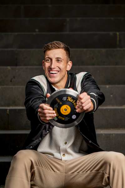 A laughing Simon Ehammer pretends to use a discus as a steering wheel.