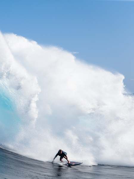 Professional big wave surfer from Maui, Hawaii, Kai Lenny, does a bottom turn at Jaws, Pe'ahi, Maui.