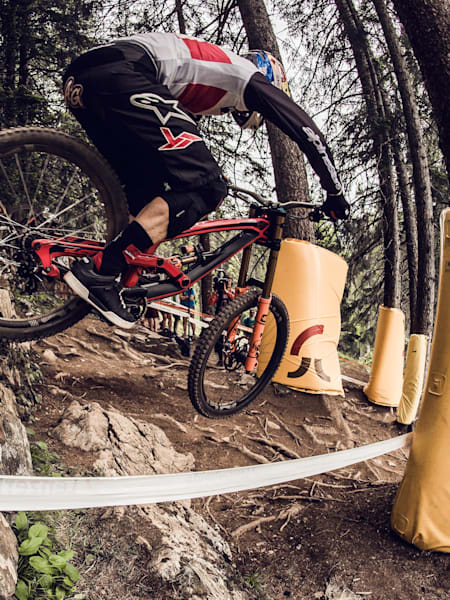 Mountain biker going over rocky drop